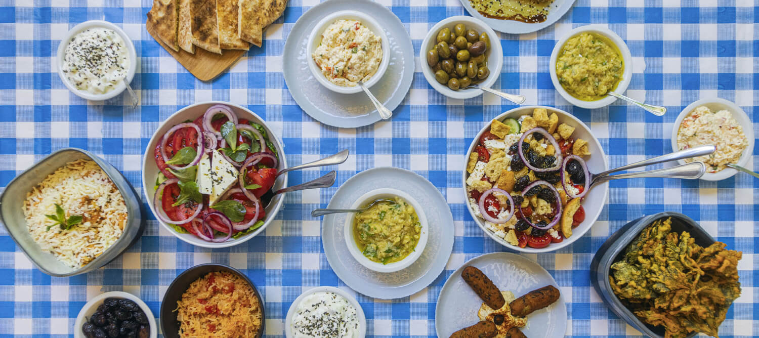 Cypriot meze platter with dips, olives, grilled halloumi, and pita bread