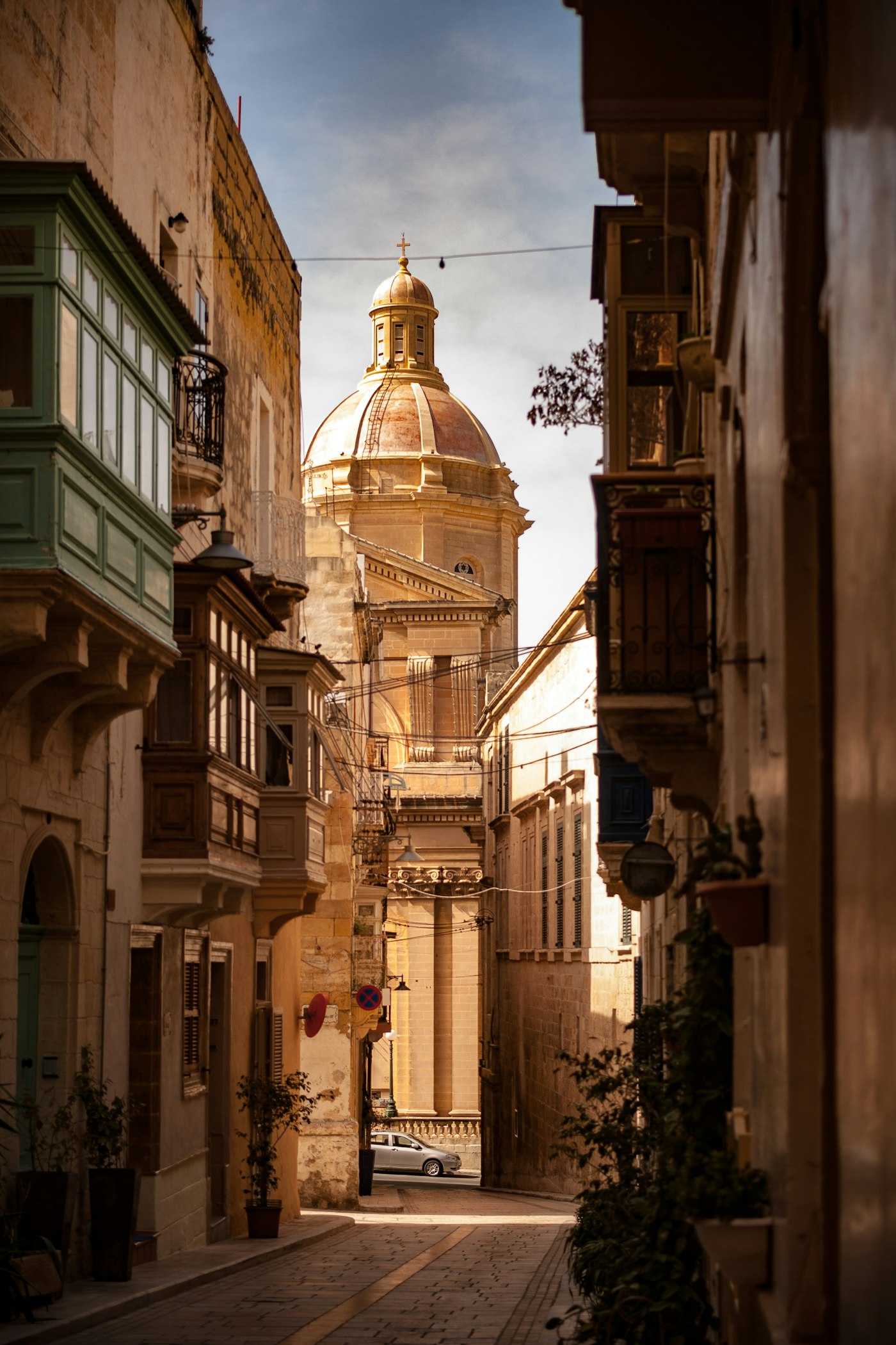 Stone street and warm-toned building in an old coastal quarter