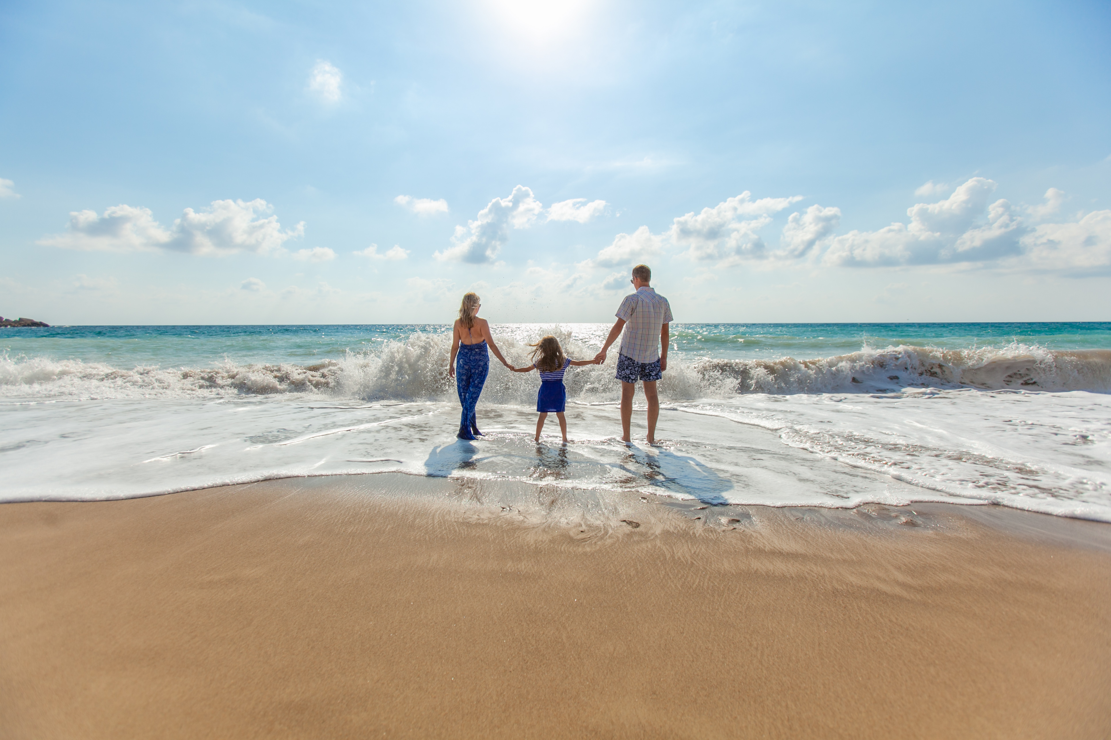 Family holding hands at the beach in Cyprus